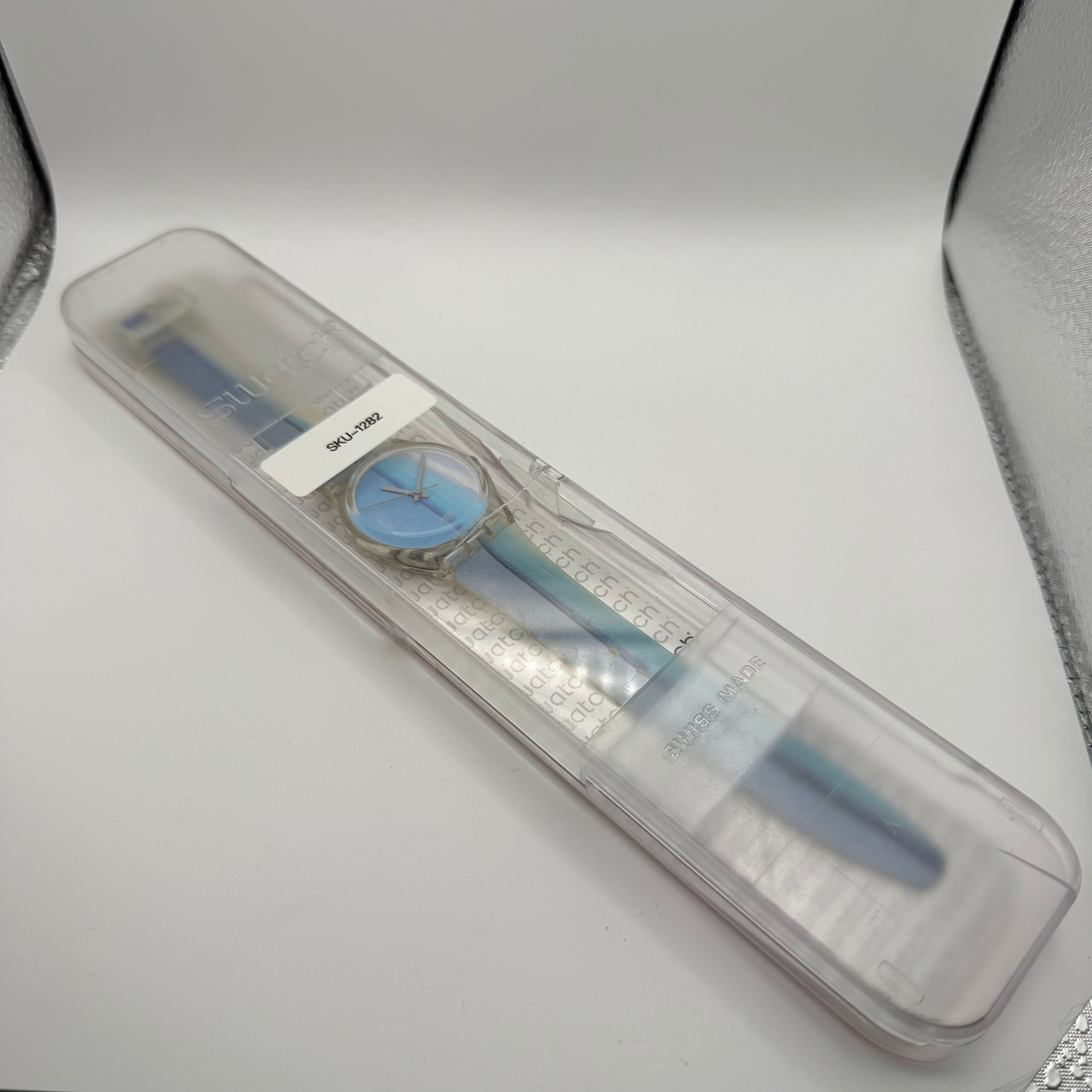 Classic Swatch Quartz Watch featuring a clean minimalist dial with blue gradient stripe- £28.99